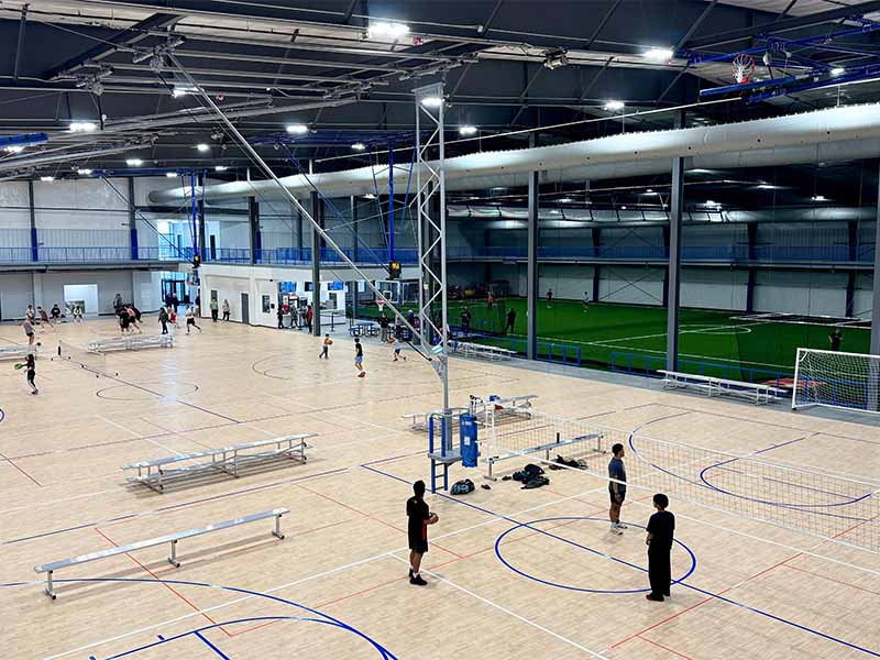 Wide view of multiple indoor basketball and turf courts at Southeast Iowa Sports Center